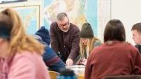 Professor with student in classroom